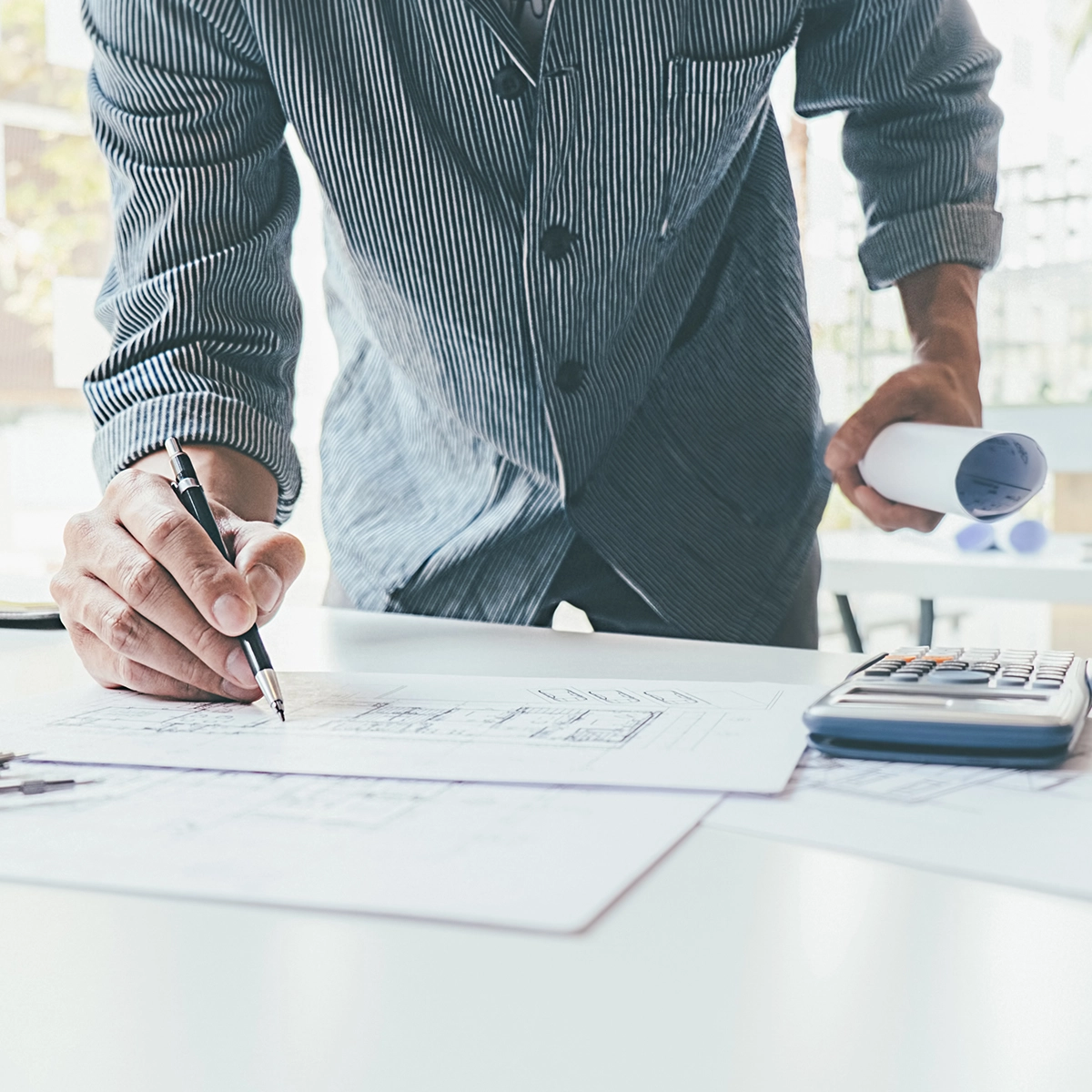 Person writing on a sheet of paper