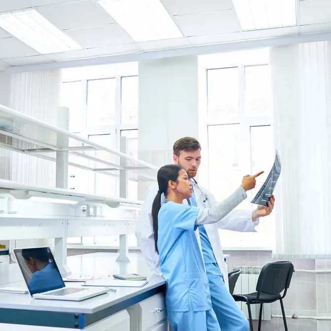Deux médecins pointant du doigt une feuille de papier